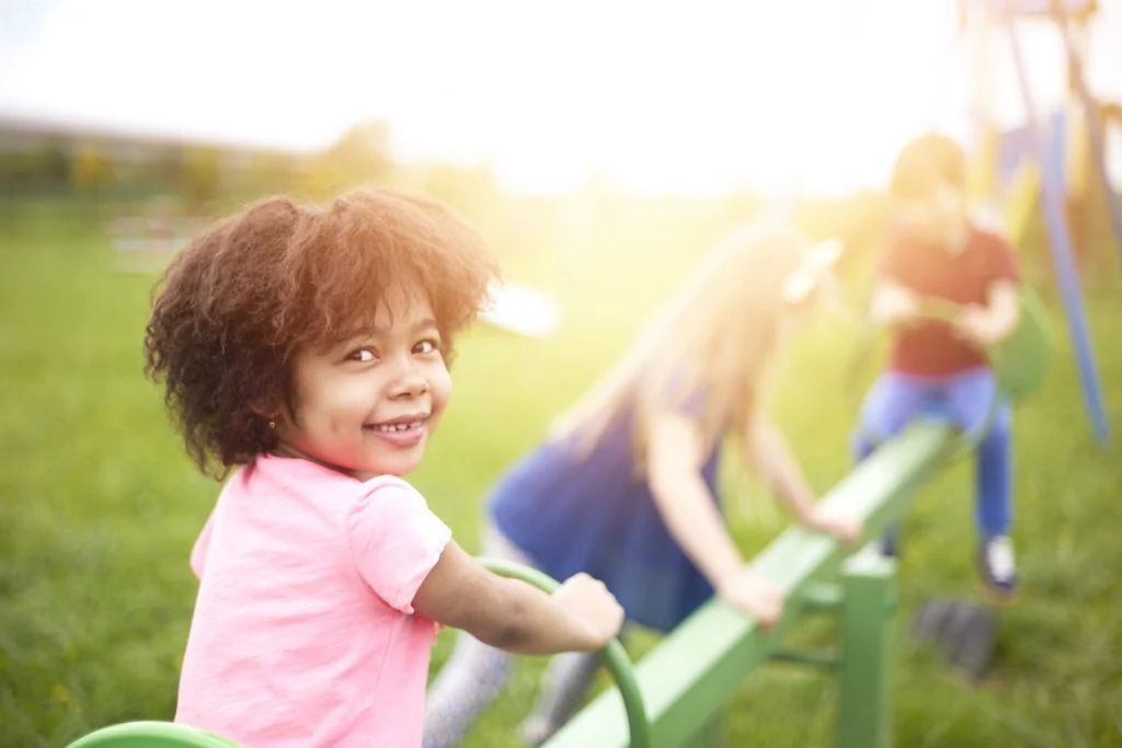 A child on a swing at the West Side Helping Hand playground